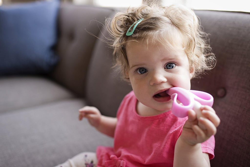®Pink Teether-Toothbrush, Infant to Toddler, Made in USA, Butter-Soft Bristles for Gums and Teeth, Bendable Food Grade Silicone, Family-Owned Buisness since 2009, 11 Million+ Sold